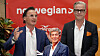Petter Stordalen and Magnus Wikner stand in front of a Norwegian-branded press conference backdrop.