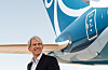 Eivind Roald stands next to a Norse Atlantic aircraft with blue branding.