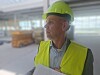 Paul Verhagen wearing a hard hat and high-visibility vest at an industrial site.